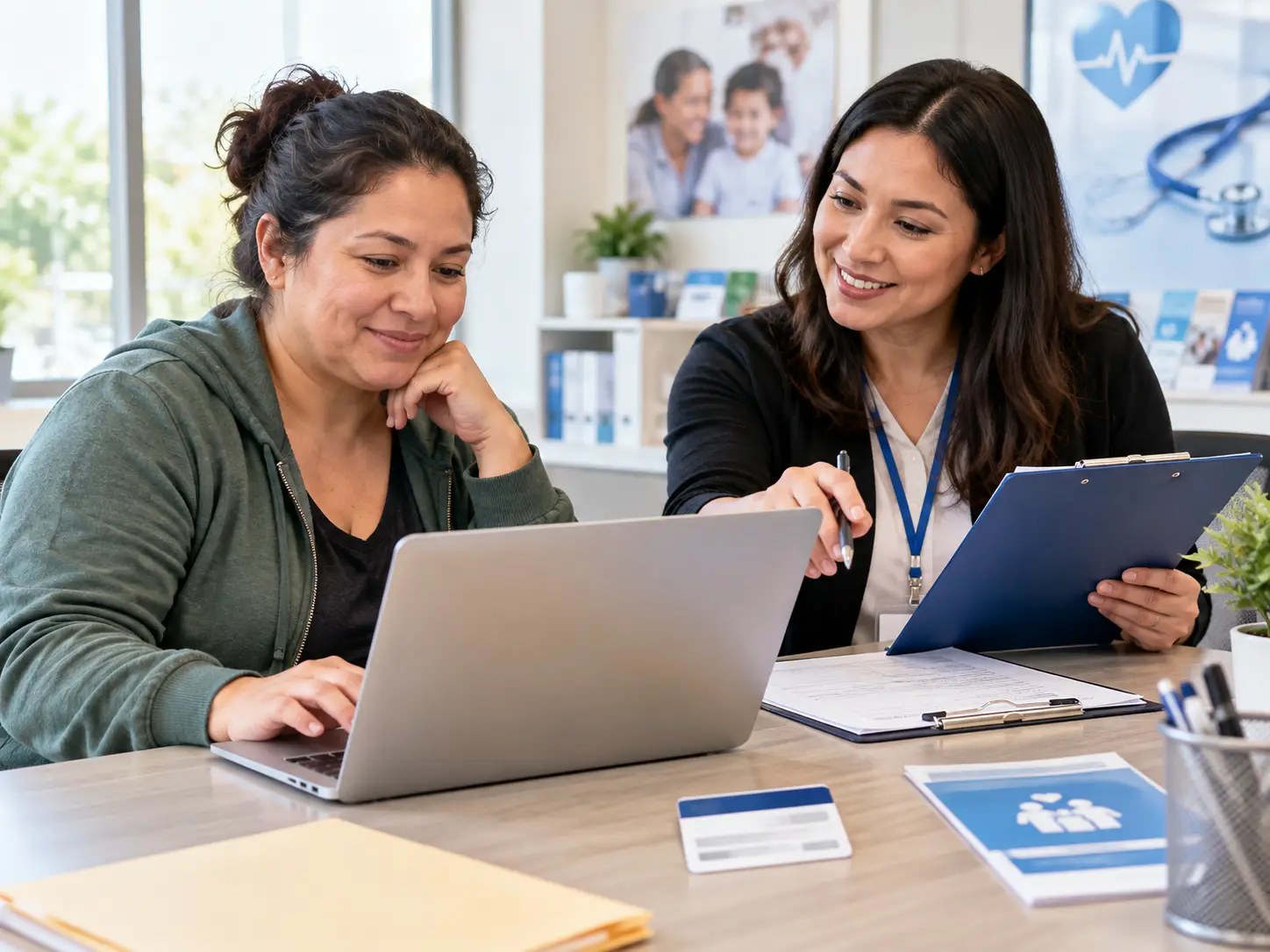 Family reviewing Medicaid and laptop program information together at a table
